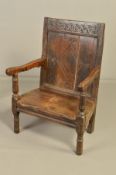 A 17TH CENTURY OAK JOINED ARMCHAIR, the rectangular back carved with a horizontal flower and