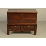 A GEORGE III OAK CHEST ON STAND, the hinged top opening to reveal a papered interior using printed