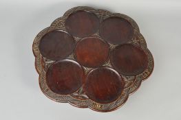 A LATE 19TH CENTURY MAHOGANY STAINED OAK LAZY SUSAN, of wavy outline, the border carved with ears of