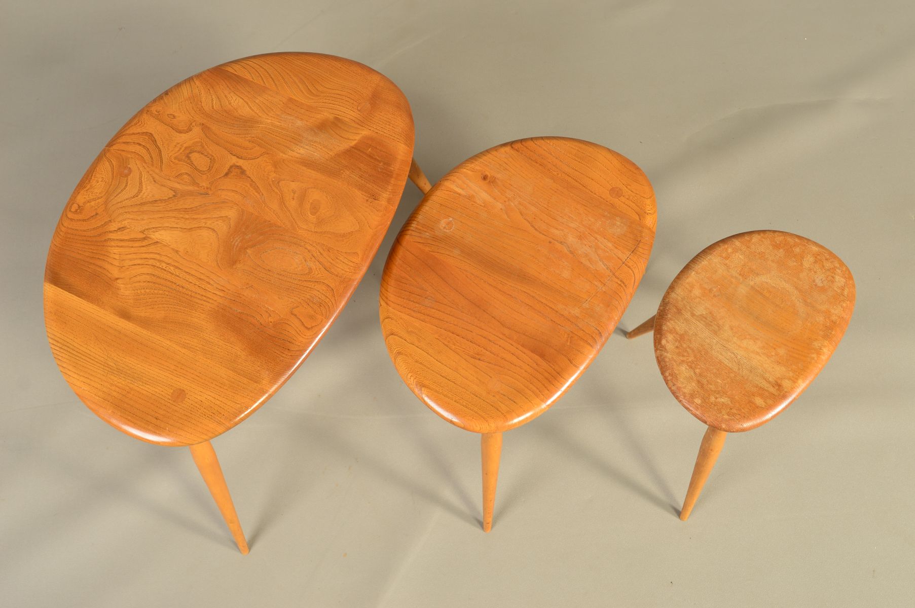 AN ERCOL BLONDE ELM PEBBLE NEST OF THREE TABLES, on triple beech cylindrical tapering legs, - Image 3 of 6
