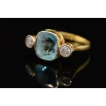A MID TO LATE 20TH CENTURY AQUAMARINE AND DIAMOND THREE STONE RING, centring on a cushion mixed