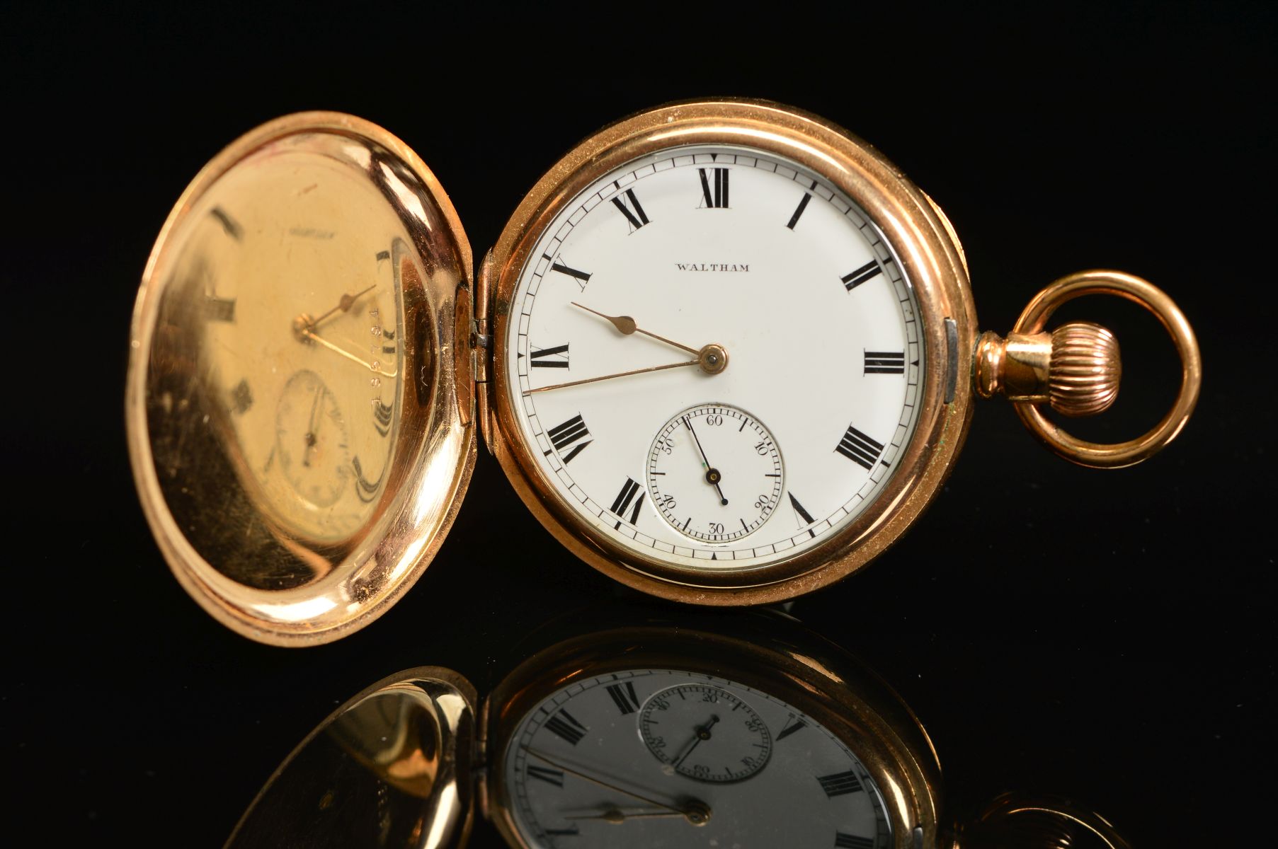 A 14K GOLD PLATED WALTHAM TOP WIND FULL HUNTER POCKET WATCH, engraved monogram to cover, enamel dial