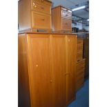 A STAG CHERRYWOOD FIVE PIECE BEDROOM SUITE comprising a triple door wardrobe, width 144cm, a chest