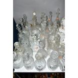 A GROUP OF TWENTY GLASS DECANTERS AND GLASS CLARET JUGS, to include cut glass, wheel etched and acid