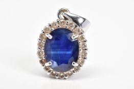 AN 18CT WHITE GOLD SAPPHIRE AND DIAMOND CLUSTER PENDANT, designed as a central oval sapphire
