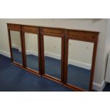 A SET OF FOUR MATCHING MAHOGANY WALL MIRRORS