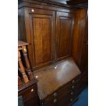 A GEORGIAN OAK AND MAHOGANY BANDED BUREAU BOOKCASE, the top with double panelled doors revealing