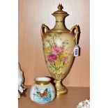 A ROYAL WORCESTER BLUSH IVORY TWIN HANDLED PEDESTAL COVERED VASE, floral decoration and gilt