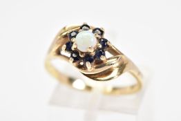 A 9CT GOLD OPAL AND SAPPHIRE CLUSTER RING, designed as a central circular opal cabochon within a