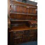 A REPRODUCTION OAK DRESSER, with two drawers and double cupboard doors, width 138cm x depth 45cm x