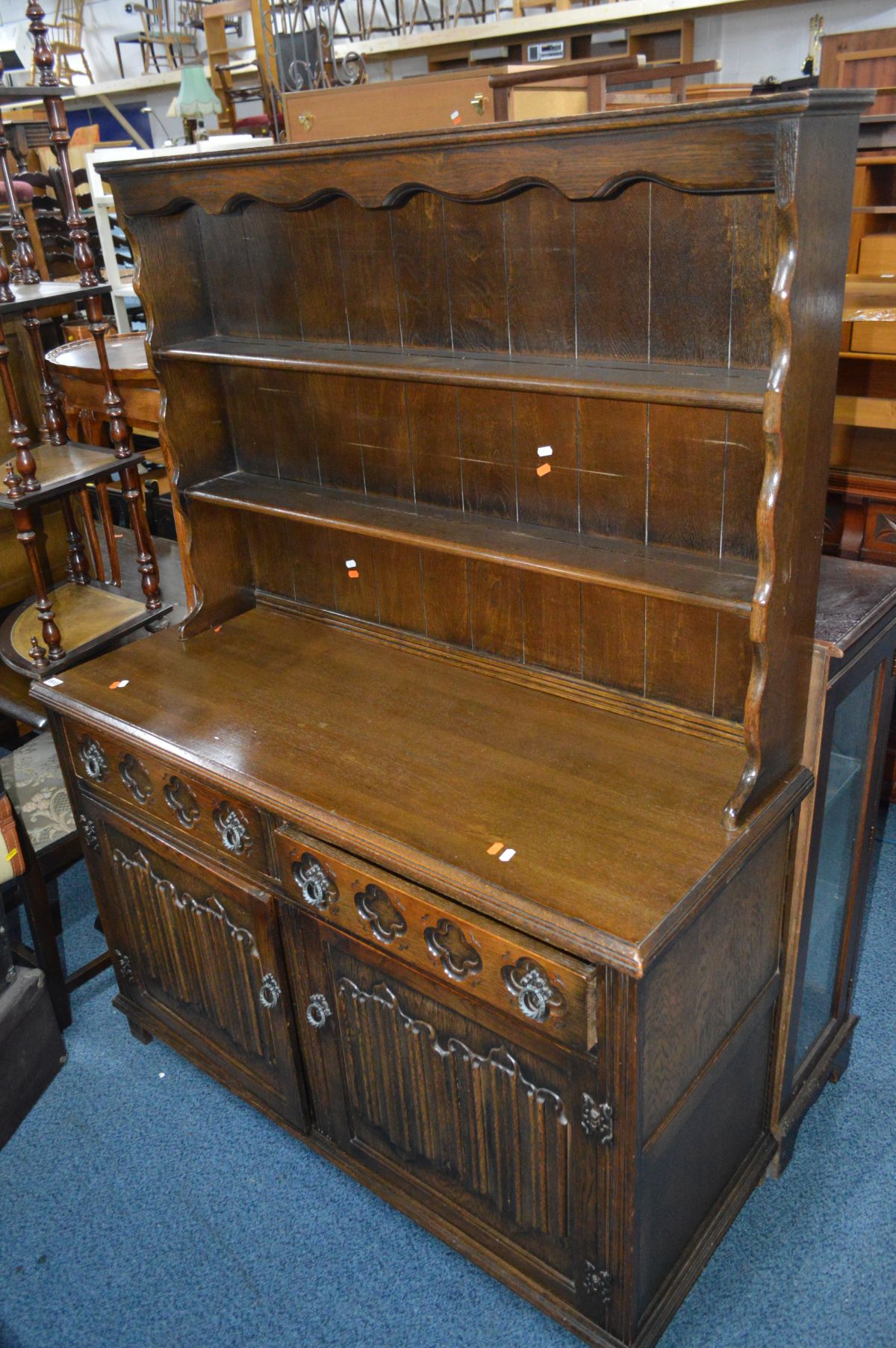 A MODERN OAK LINENFOLD DRESSER with plate rack, width 126cm x height 168cm x depth 47cm