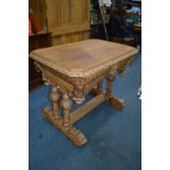 AN EARLY 20TH CENTURY OAK TABLE, canted corners above a lions mask to each corner, three lions