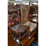 AN EARLY 20TH CENTURY CARVED OAK HALL CHAIR together with an oak bergere high back armchair and an