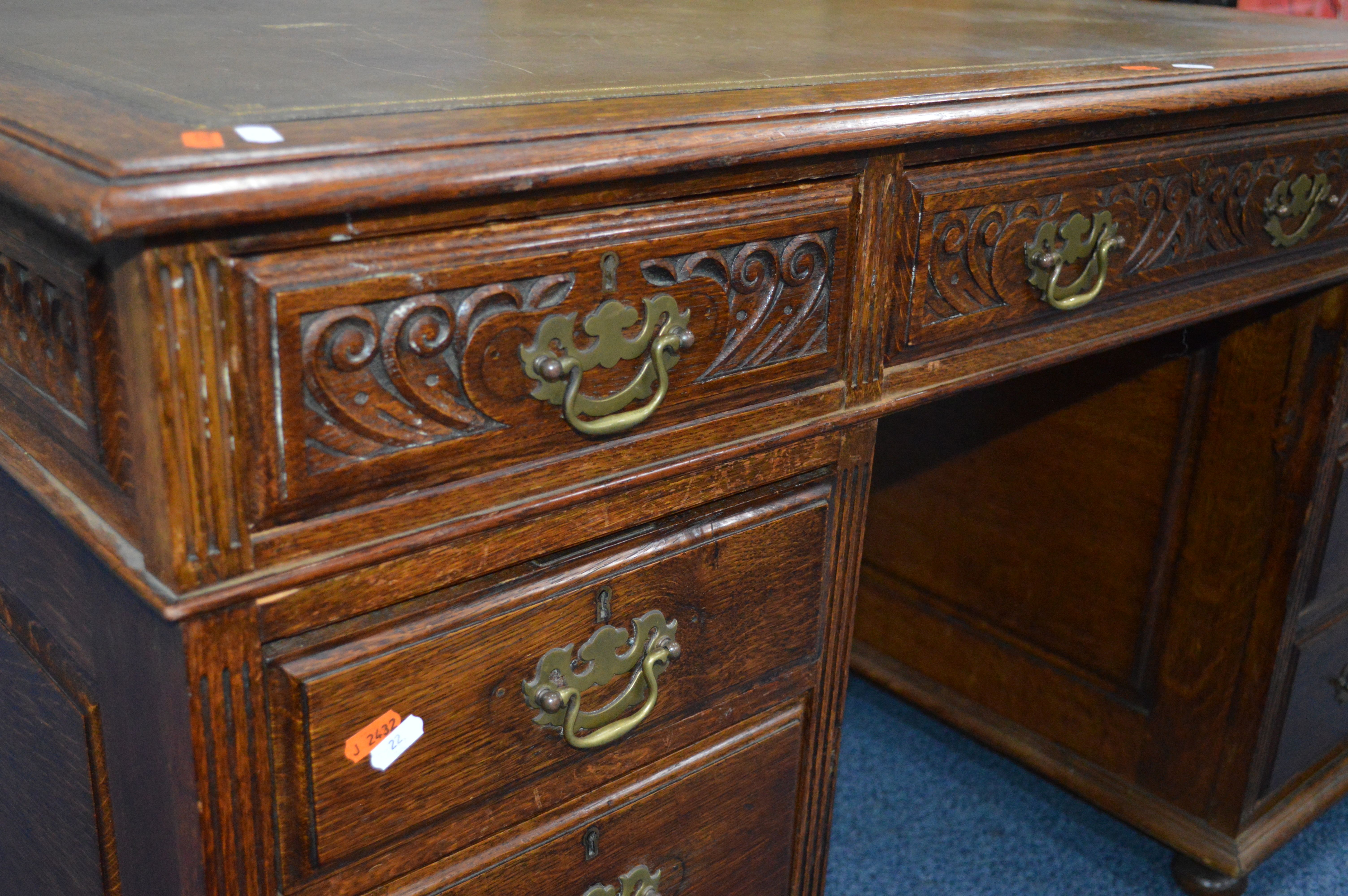 AN EARLY 20TH CENTURY CARVED OAK PEDESTAL DESK, dark green gilt tooled leather inlay top and nine - Image 3 of 3