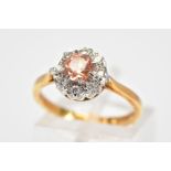 AN 18CT GOLD TOPAZ AND DIAMOND CLUSTER RING, designed with a central circular cut orange/pink