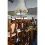 AN EARLY TO MID 20TH CENTURY OAK STANDARD LAMP on a base with an assortment of open shelves,