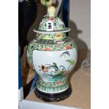 A CHINESE FAMILLE VERT JAR AND COVER, hand painted with floral and insect panels, Chrysanthemum