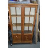 AN EARLY 20TH CENTURY GOLDEN OAK GLAZED TWO DOOR BOOKCASE, width 79cm x depth 27cm x height 154cm (