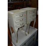 A PAIR OF CREAM AND GILT BEDSIDE CHESTS of three drawers on cabriole legs, width 36cm x height