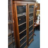 AN EDWARDIAN MAHOGANY BOOKCASE with two glazed doors, width 102cm x height 181cm x depth 32cm