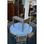 A MODERN PAINTED CIRCULAR KITCHEN TABLE, four chairs, glass topped occasional table and a mirrored