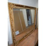 A LARGE LATE 20TH CENTURY FOLIATE GILT PLASTER BEVELLED EDGE WALL MIRROR, 200cm x 170cm (sd to