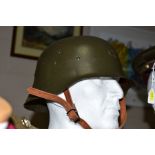 AN EXAMPLE OF AN M42 GERMAN WWII STEEL HELMET, in Wehrmakt green colour, leather chin strap and