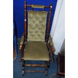 AN EDWARDIAN WALNUT AMERICAN ROCKING CHAIR