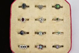 TWELVE SILVER AND WHITE METAL RINGS, to include a two marcasite rings, a cubic zirconia cluster