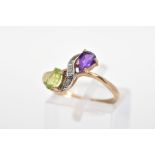 A 9CT GOLD AMETHYST AND PERIDOT RING, of crossover design set with a pear cut amethyst and peridot