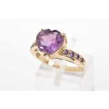 A 9CT GOLD AMETHYST RING, the heart shape amethyst within a three claw setting to the amethyst set