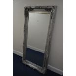 A LATE 20TH CENTURY FOLIATE SILVER PAINTED RECTANGULAR BEVELLED EDGE WALL MIRROR, 172cm x 86cm (sd