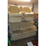 AN OATMEAL BUTTONED WINGBACK THREE PIECE LOUNGE SUITE, comprising of a three seater settee and a