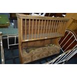 AN EARLY 20TH CENTURY PINE HANGING PLATE RACK with five drawers together with a brass three piece