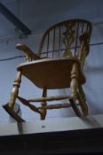 A LATE 20TH CENTURY BEECH SPINDLE BACK ROCKING CHAIR