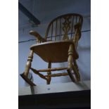 A LATE 20TH CENTURY BEECH SPINDLE BACK ROCKING CHAIR