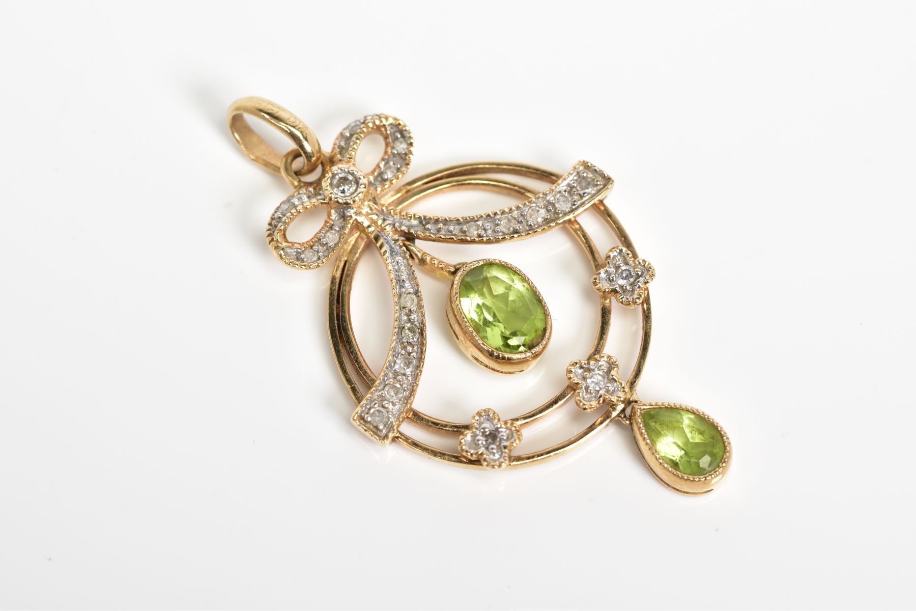 A 9CT GOLD DIAMOND AND PERIDOT SET PENDANT, the open work circular design suspending a pear and oval