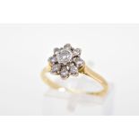 A DIAMOND CLUSTER RING, set with nine brilliant cut diamonds, to the tapered shoulders, total