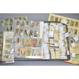A LARGE COLLECTION OF SEVERAL THOUSANDS OF GALLAHER CIGARETTE CARDS in one album and one lock spring