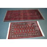 A 20TH CENTURY BELOUTCH RED GROUND RUG, 220cm x 107cm, together with a tekke red ground rug (2)