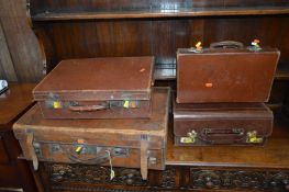 A VINTAGE BROWN LEATHER SUITCASE, a gent's briefcase and two other suitcases (sd) (4)