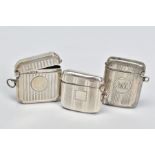 THREE EDWARDIAN/GEORGE V SILVER RECTANGULAR VESTA CASES, all with engine turned decoration, one
