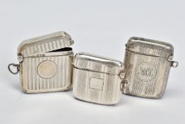 THREE EDWARDIAN/GEORGE V SILVER RECTANGULAR VESTA CASES, all with engine turned decoration, one