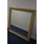 AN EARLY 20TH CENTURY SQUARE PINE WALL MIRROR, 132cm squared