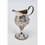 A GEORGE III SILVER CREAM JUG, of baluster form with pedestal, embossed scrolling and floral