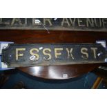 AN EARLY 20TH CENTURY BLACK GROUND CAST IRON ROAD SIGN reading Essex St, width 81cm