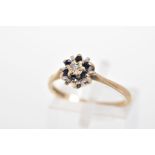 A 9CT GOLD SAPPHIRE AND DIAMOND RING, of tiered design with a central single cut diamond and