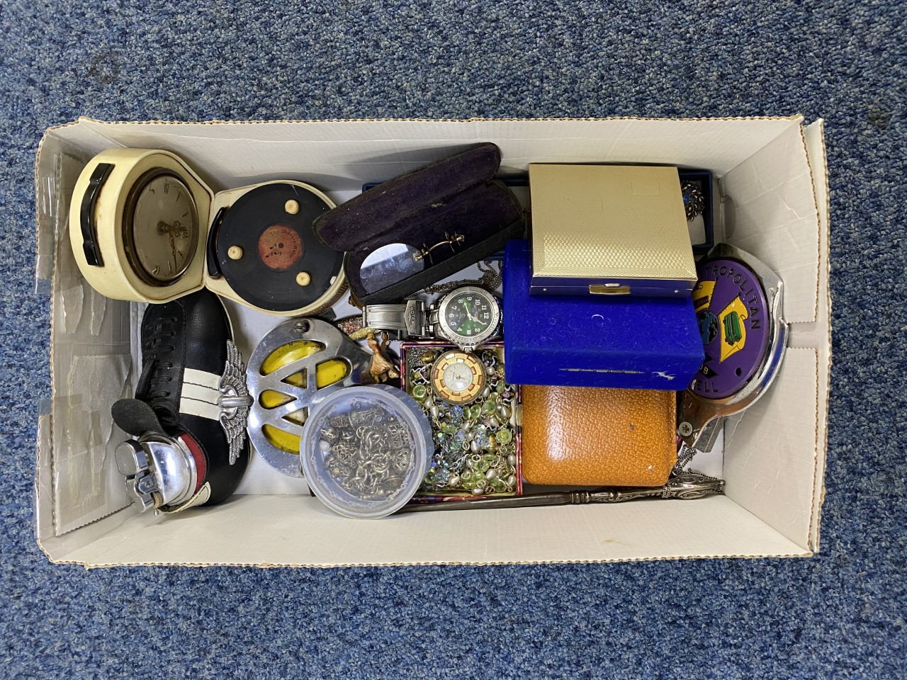 A BOX CONTAINING COSTUME JEWELLERY, CAR BADGES, CHARM BRACELET, WRISTWATCHES AND A SILVER HANDED
