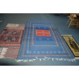 A MOROCCAN KLIM BLUE AND RED GROUND RUG, 260cm x 158cm together with a red ground Kilim rug 196cm