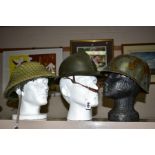 THREE MILITARY HELMETS, a French WWI/II era Adrianne helmet in steel with French RF badge attached